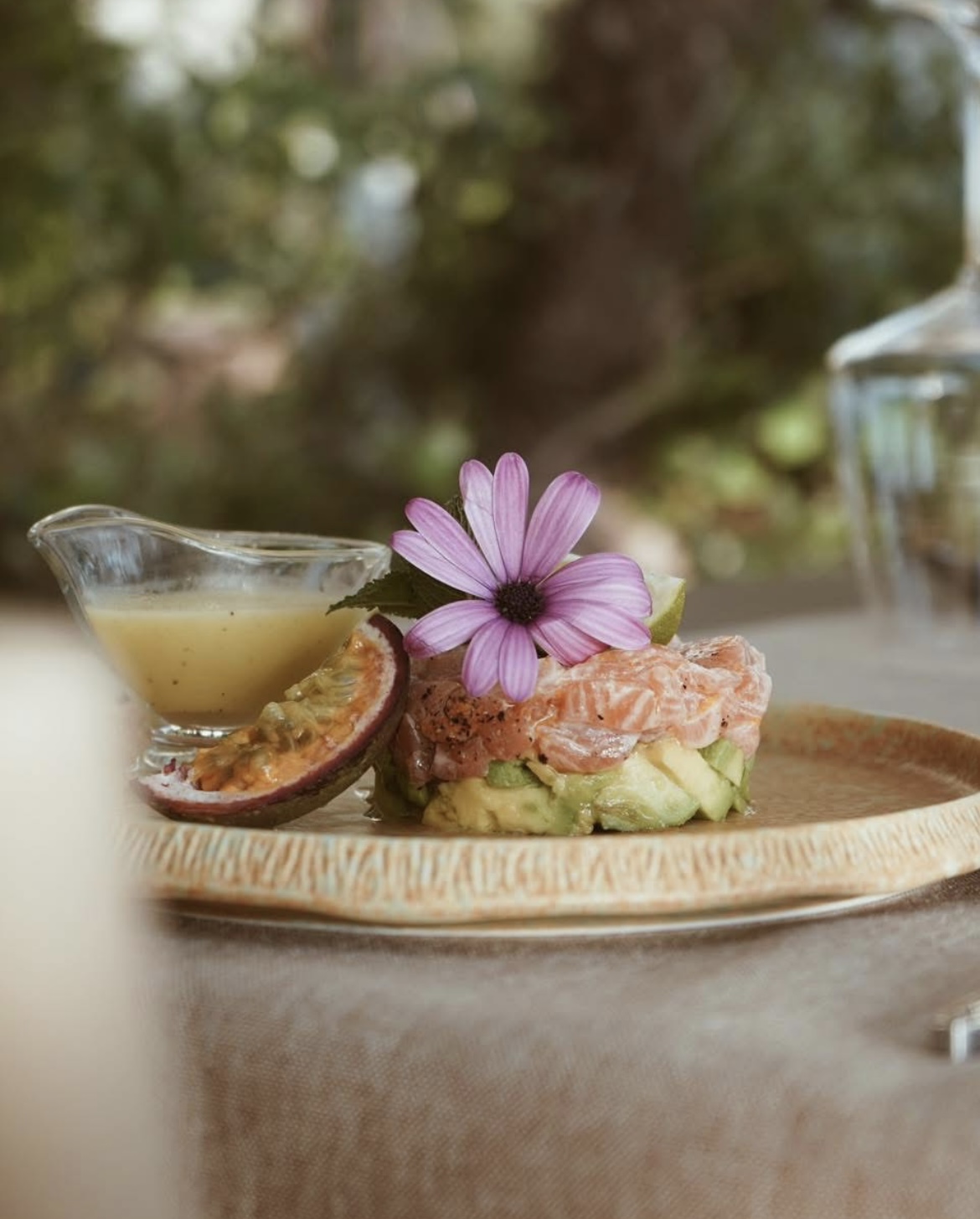 Salmon tartare with passion fruit and edible flower
